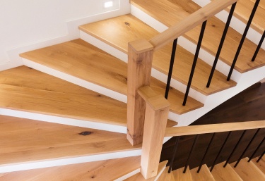 hardwood staircase with iron spindles