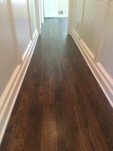 Dark-stained hardwood floor hallway